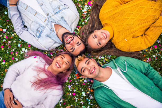 istock Group of young students bonding outdoors 1286843110