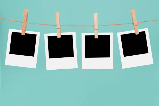 istock Clothesline with empty  picture frames and clothespins on a blue background 1286843130