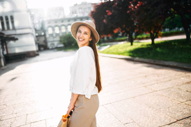 istock Charming woman in hat walks in the downtown 1286844330