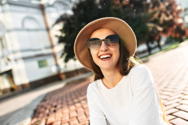 istock Charming woman in hat walks in the downtown 1286844342