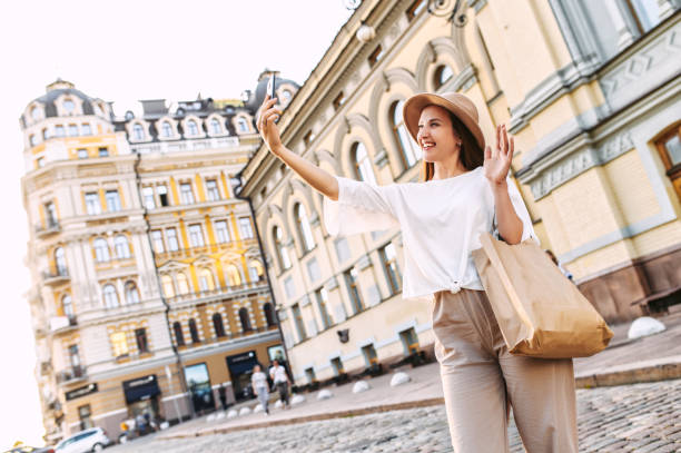 istock Cheerful young woman in hat is taking selfie 1286844347