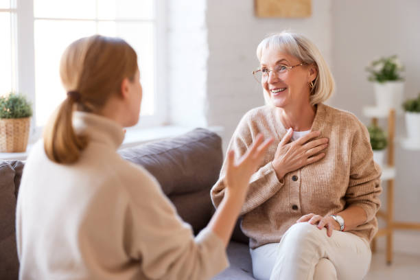 istock Happy women chatting on sofa at home 1286844453