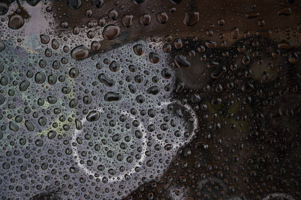 istock Rain drops on glass background. Raindrops on glass with reflection 1286845529