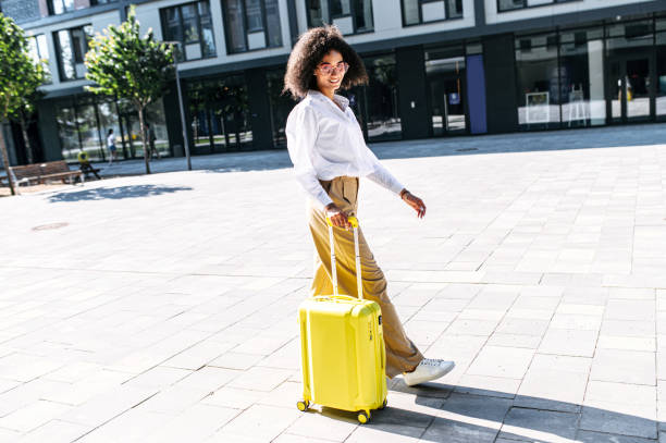 istock A beautiful woman with a suitcase outdoors 1286845741