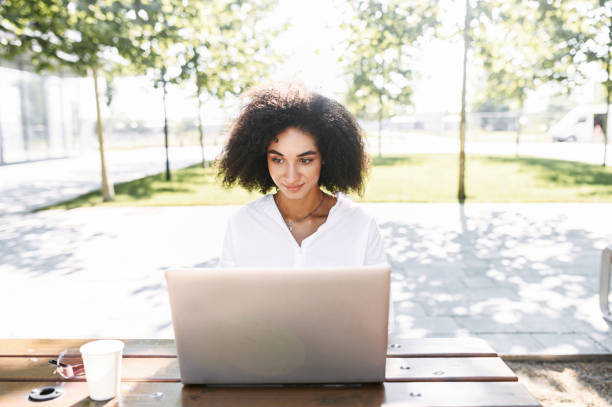 istock A woman using a laptop for work outdoors 1286845755