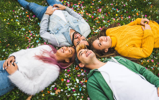 istock Group of young students bonding outdoors 1286846396