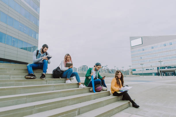 istock Group of young students bonding outdoors 1286846431