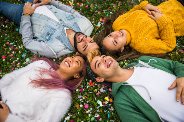 istock Group of young students bonding outdoors 1286846483