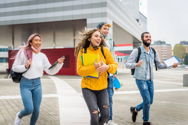 istock Group of young students bonding outdoors 1286846512