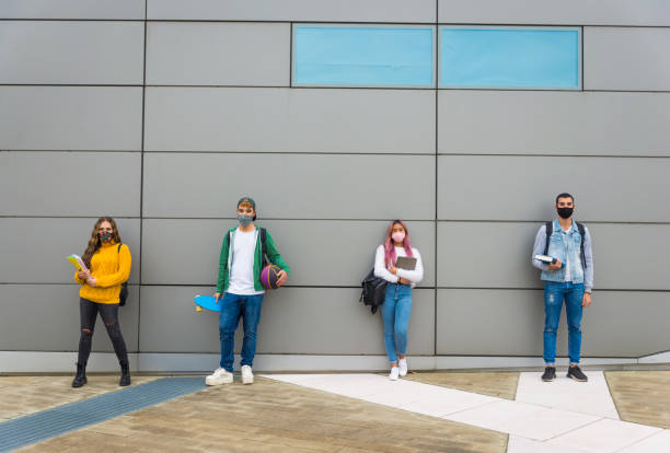 istock Group of young students bonding outdoors 1286846729