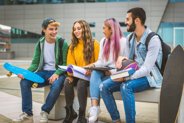 istock Group of young students bonding outdoors 1286846823