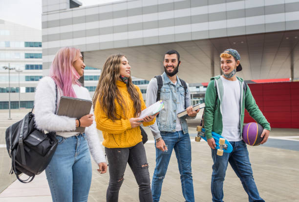 istock Group of young students bonding outdoors 1286847023
