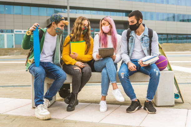 istock Group of young students bonding outdoors 1286847651
