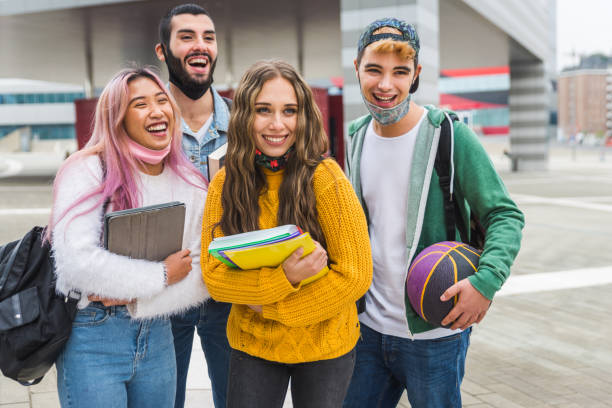 istock Group of young students bonding outdoors 1286847733