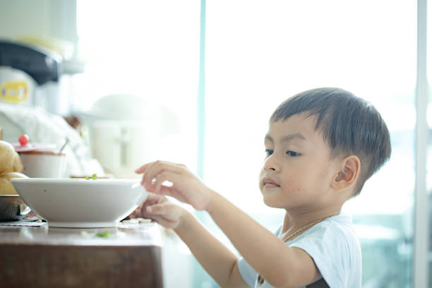 istock Little boy playing coriander in the kitchen 1286849191