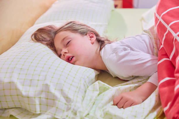 istock funny face of little child sleeping on bed 1286850371
