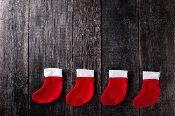 istock Christmas stockings on wooden rustic background 1286850574