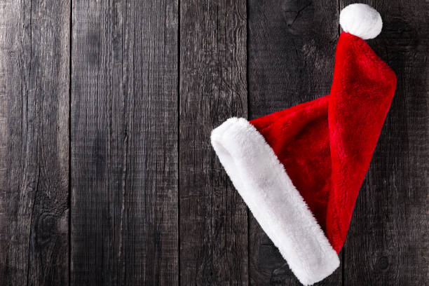 istock Santa Claus hat on wooden rustic background 1286850859