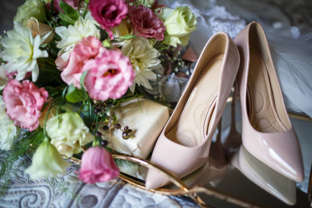 istock Wedding shoes with bouquet on bed 1286850990