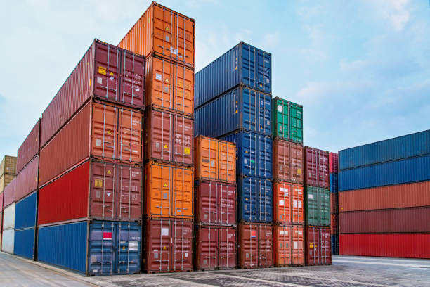 istock Multicolor shipping containers stacked high at a port. 1286851052