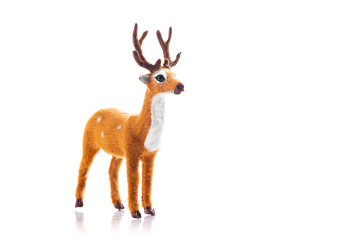 Deer toy isolated on white background. New Year celebration