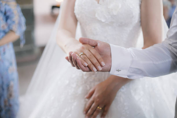 istock Bride and groom holding hands in church 1286851241