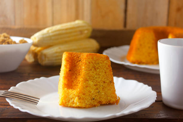 istock corn cake sliced on white plate on rustic wooden table. Typical Brazilian food. Front view. 1286852063