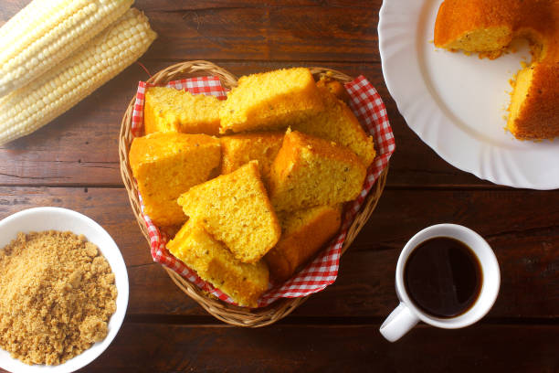 corn cake sliced in basket on rustic wooden table for breakfast. Typical Brazilian food.