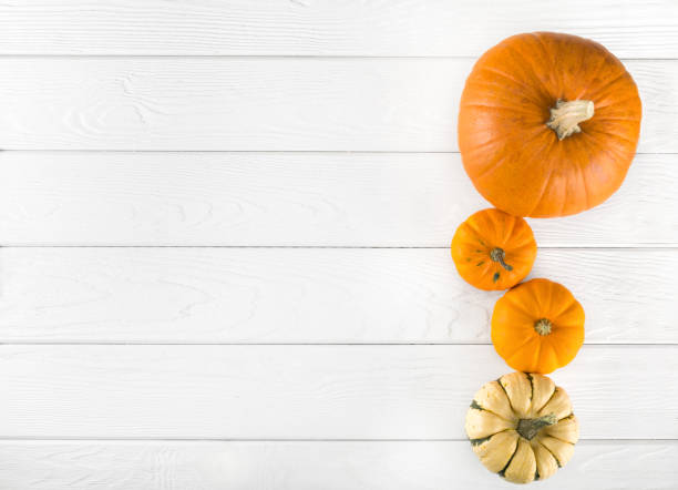 istock Ripe pumpkin on wooden background 1286852274