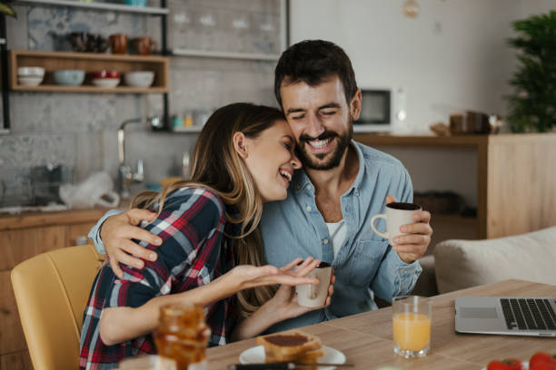 istock Happy couple having fun while laughing in the kitchen 1286853623