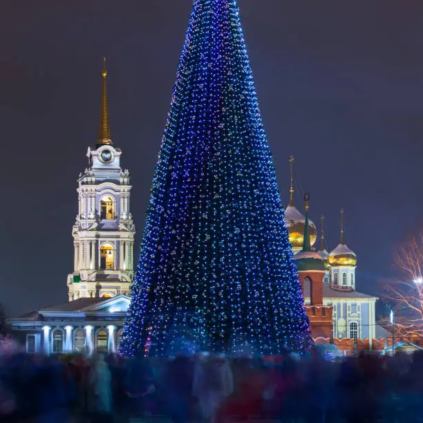 Christmas tree at night in central city square with crowd blurred by long exposure. Tula, Russia, 2018