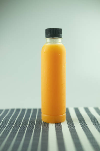 istock Bottle with delicious fresh orange juice. Healthy drink 1286854236