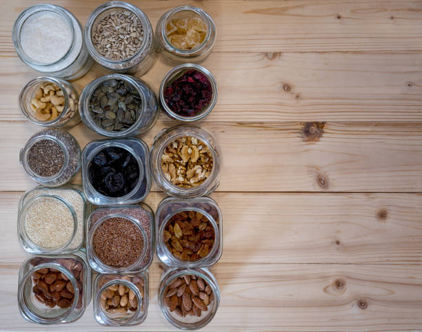 istock Seed,nut and dried fruits in various jars over wood background. 1286854444