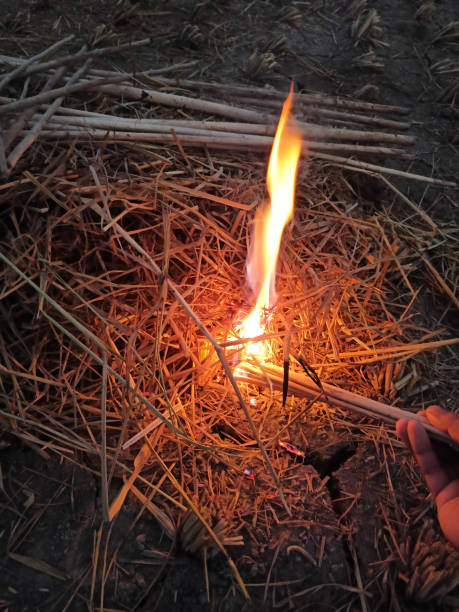 istock A haystake is being set on fire with a buring jute stick at a rural area in the winter 1286856901