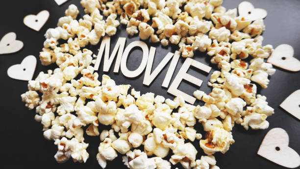 istock Popcorn on black background. Watching a movie with popcorn. Copy space 1286857098