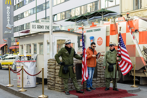 Berlin / Germany - February 15, 2017: Tourist taking photos at Checkpoint Charlie, the best-known Berlin Wall crossing point between East Berlin and West Berlin during the Cold War