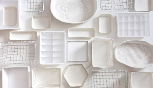 Flat lay of Marie Kondo's white storage boxes, containers and baskets with different sizes and shapes