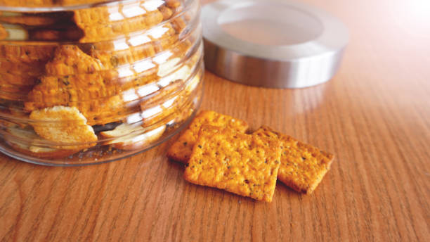 istock Wheat cracker in a glass jar on wooden table. 1286859357