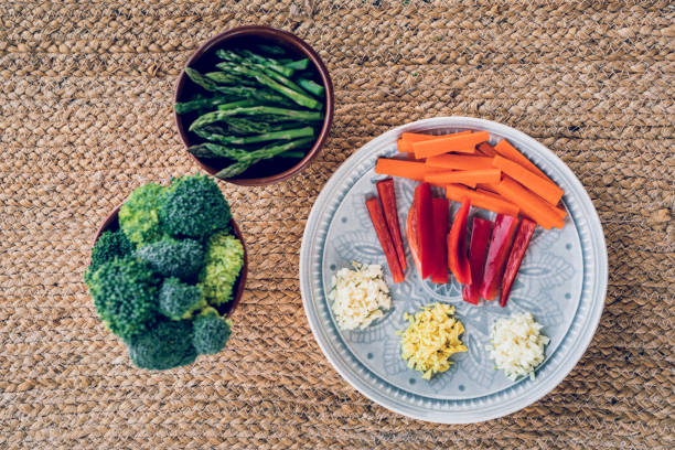 istock Close-up of broccoli, asparagus and other vegetables on raffia background 1286859701