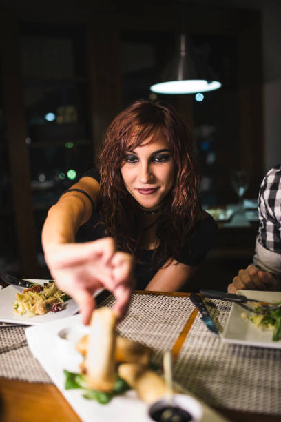 istock Young modern couple in restaurant drinking wine with ambient light 1286862317