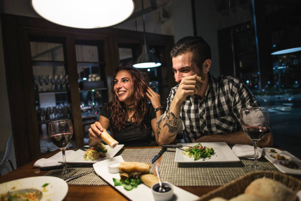 istock Young couple laughing in restaurant in wide angle image with ambient light, laughing happy 1286862318