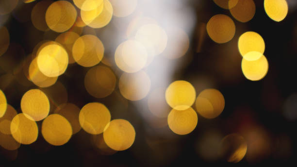 istock Defocused gold lights on the black background 1286863242