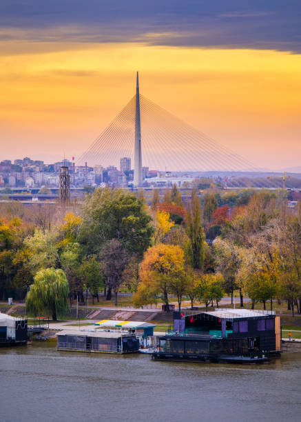 Belgrade / Serbia - November 16, 2019: Colorful sunset over Sava river in Belgrade, capital of Serbia, with Ada bridge in the background