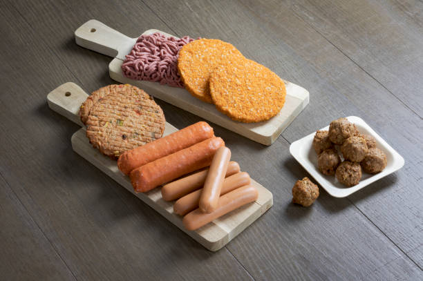 Flat lay of plant based vegetarian meat products Display of plant based vegetarian meat products for a plant based diet on a wooden table veggie burger photos stock pictures, royalty-free photos & images