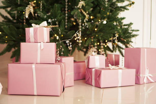 istock Pink present boxes with ribbons under the Christmas tree 1286864575