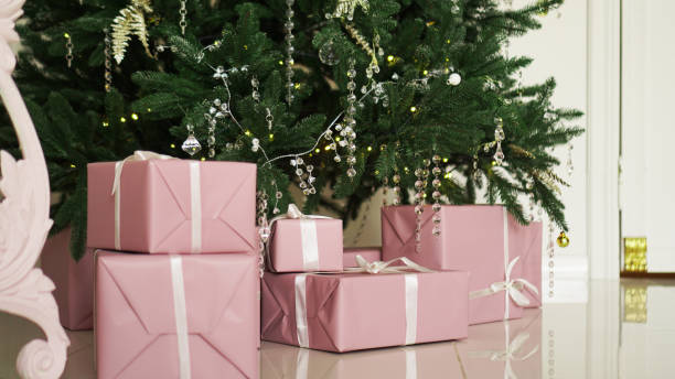 istock Pink present boxes with ribbons under the Christmas tree 1286864598