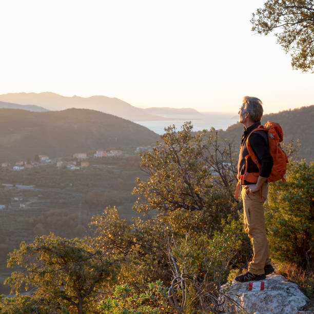 istock Hiker relaxes on mountain ridge at sunrise 1286866100