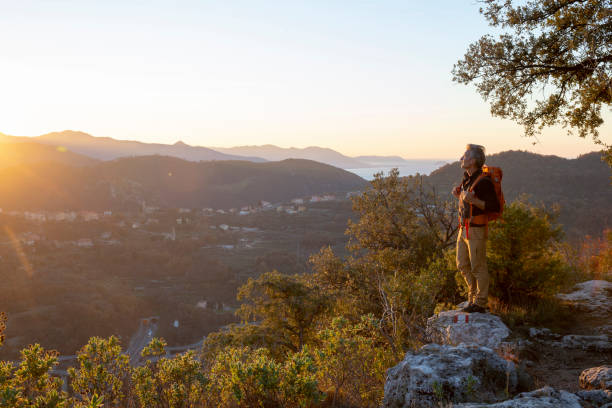 istock Hiker relaxes on mountain ridge at sunrise 1286866105