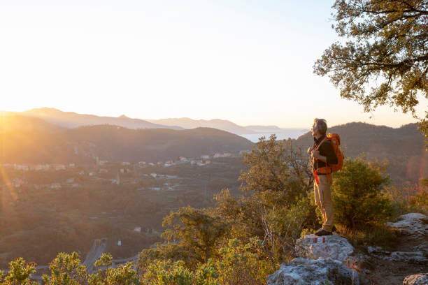 istock Hiker relaxes on mountain ridge at sunrise 1286866212