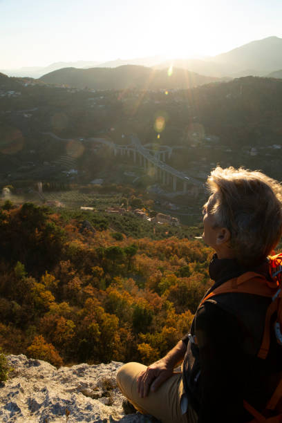 istock Hiker relaxes on mountain ridge at sunrise 1286866259